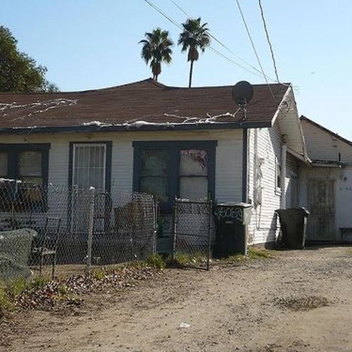 Small distressed property with debris